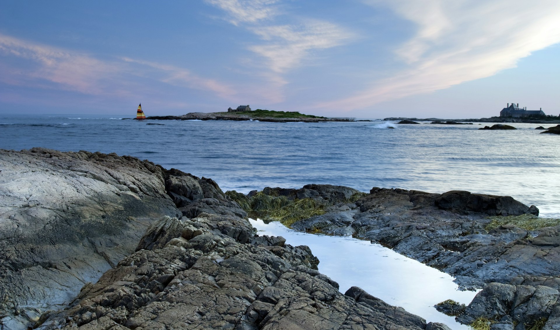 A catamaran sails just off Gooseberry Beach in Newport, Rhode Island 