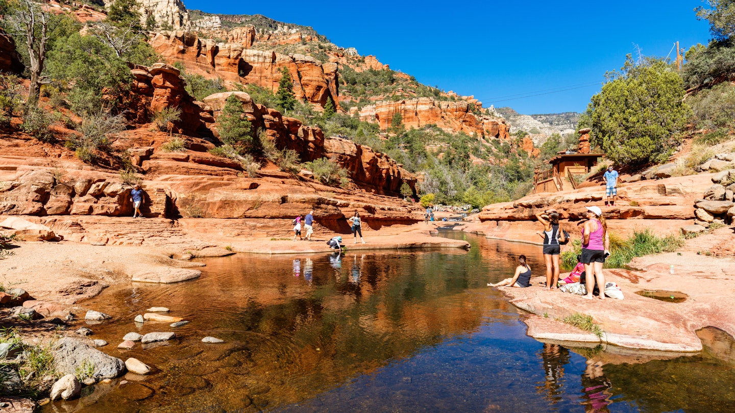 Coconino, AZ USA - October 17, 2016: Visitors enjoying the beauty of Slide Rock State Park with its natural rock water slides in the Oak Creek Canyon near Sedona.; Shutterstock ID 619981541; your: Tasmin Waby; gl: 65050; netsuite: Online Editorial; full: Demand Project