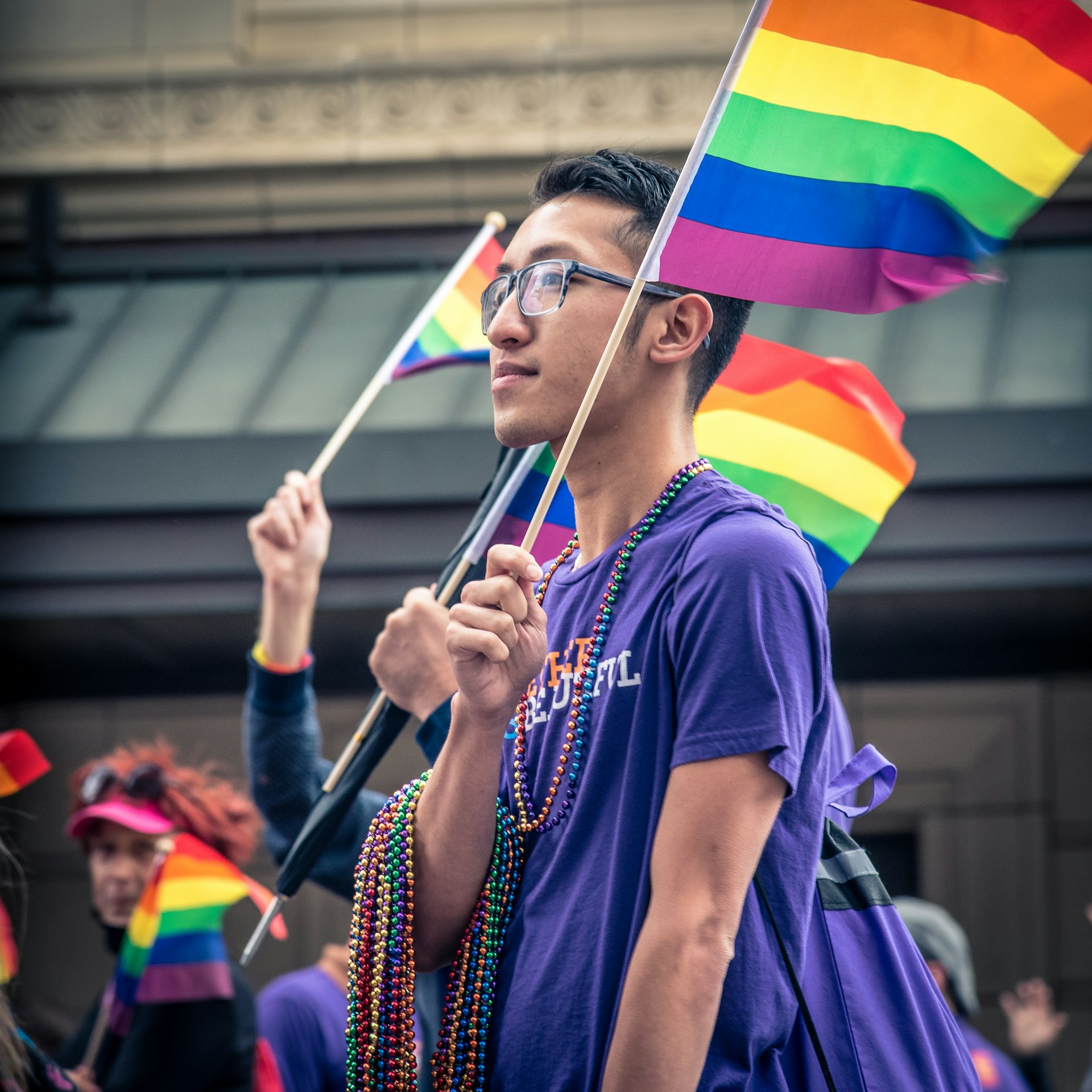 Man carrying a Pride flag at the Twin Cities Pride Celebration in Minneapolis