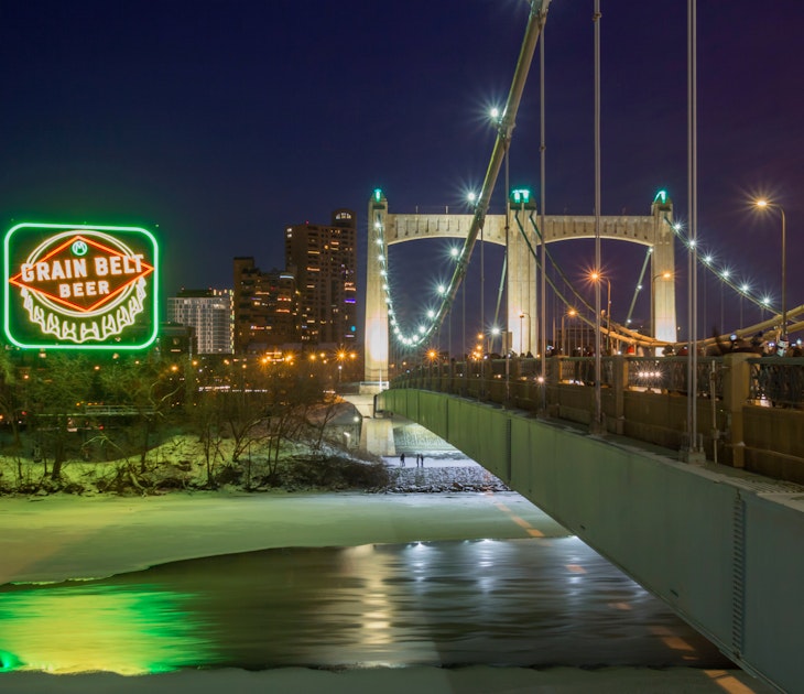MINNEAPOLIS, MN - DECEMBER 2017 - A Long Exposure Night Shot of the Inaugural Relighting of the Iconic Grain Belt Beer Sign along the Frozen Mississippi River by the Hennepin Avenue Bridge in Winter; Shutterstock ID 785287246; your: Tasmin Waby; gl: 65050; netsuite: Online editorial; full: Core Demand