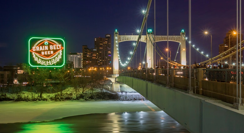 MINNEAPOLIS, MN - DECEMBER 2017 - A Long Exposure Night Shot of the Inaugural Relighting of the Iconic Grain Belt Beer Sign along the Frozen Mississippi River by the Hennepin Avenue Bridge in Winter; Shutterstock ID 785287246; your: Tasmin Waby; gl: 65050; netsuite: Online editorial; full: Core Demand