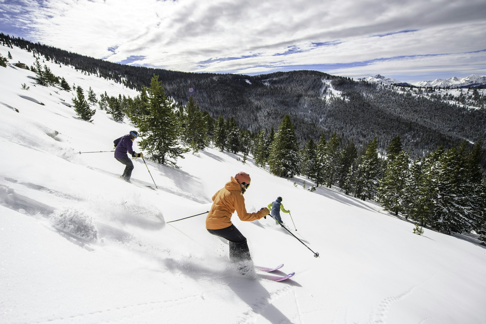 Skiers riding down the Blue Sky Basin in Vail, Colorado