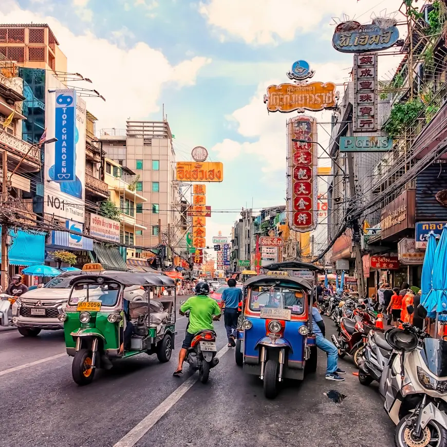 Tuk-tuks await passengers on Yaowarat Road in Chinatown, Bangkok