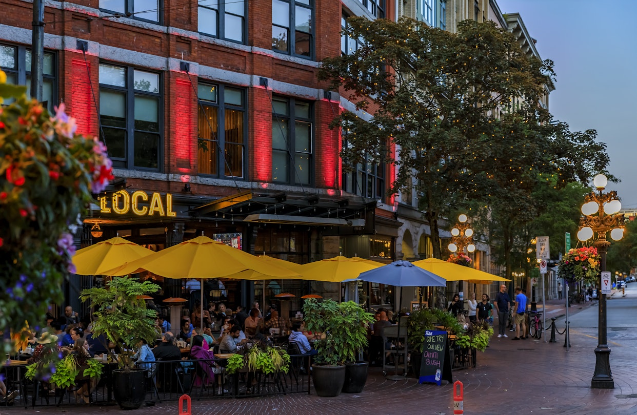 Vancouver, Canada - July 09 2019: Quaint restaurant on the popular Cambie street with hanging flower baskets in the heart of Gastown heritage district