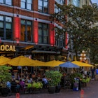 Vancouver, Canada - July 09 2019: Quaint restaurant on the popular Cambie street with hanging flower baskets in the heart of Gastown heritage district