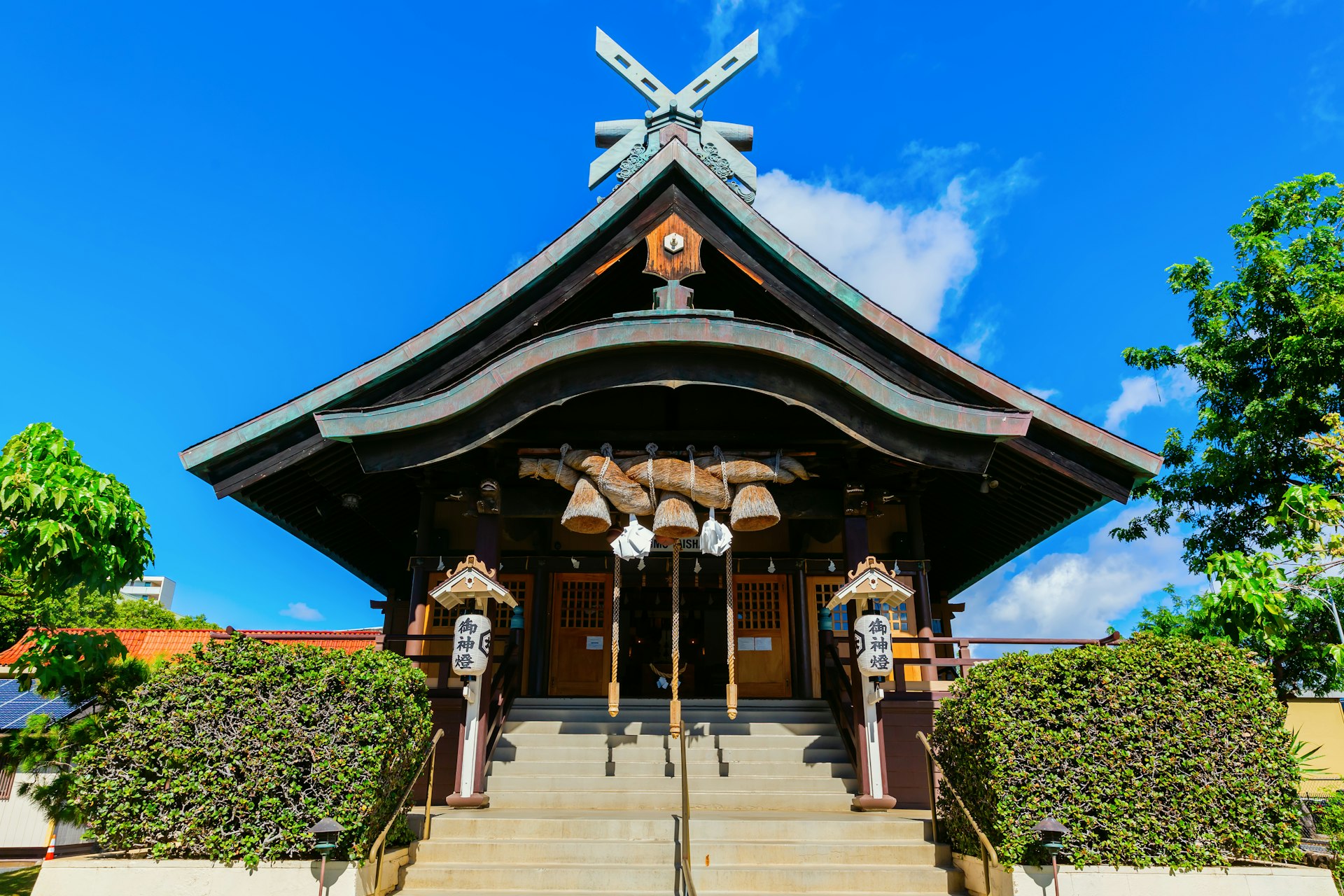 The steps up to a Japanese-style shrine with a pointed wooden roof