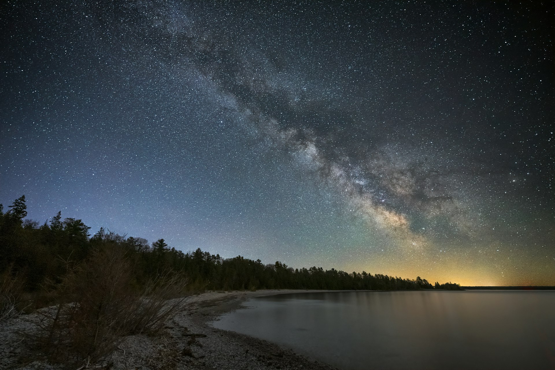 The night sky lit up by millions of stars above a body of water at Headlands International Dark Sky Park, Michigan