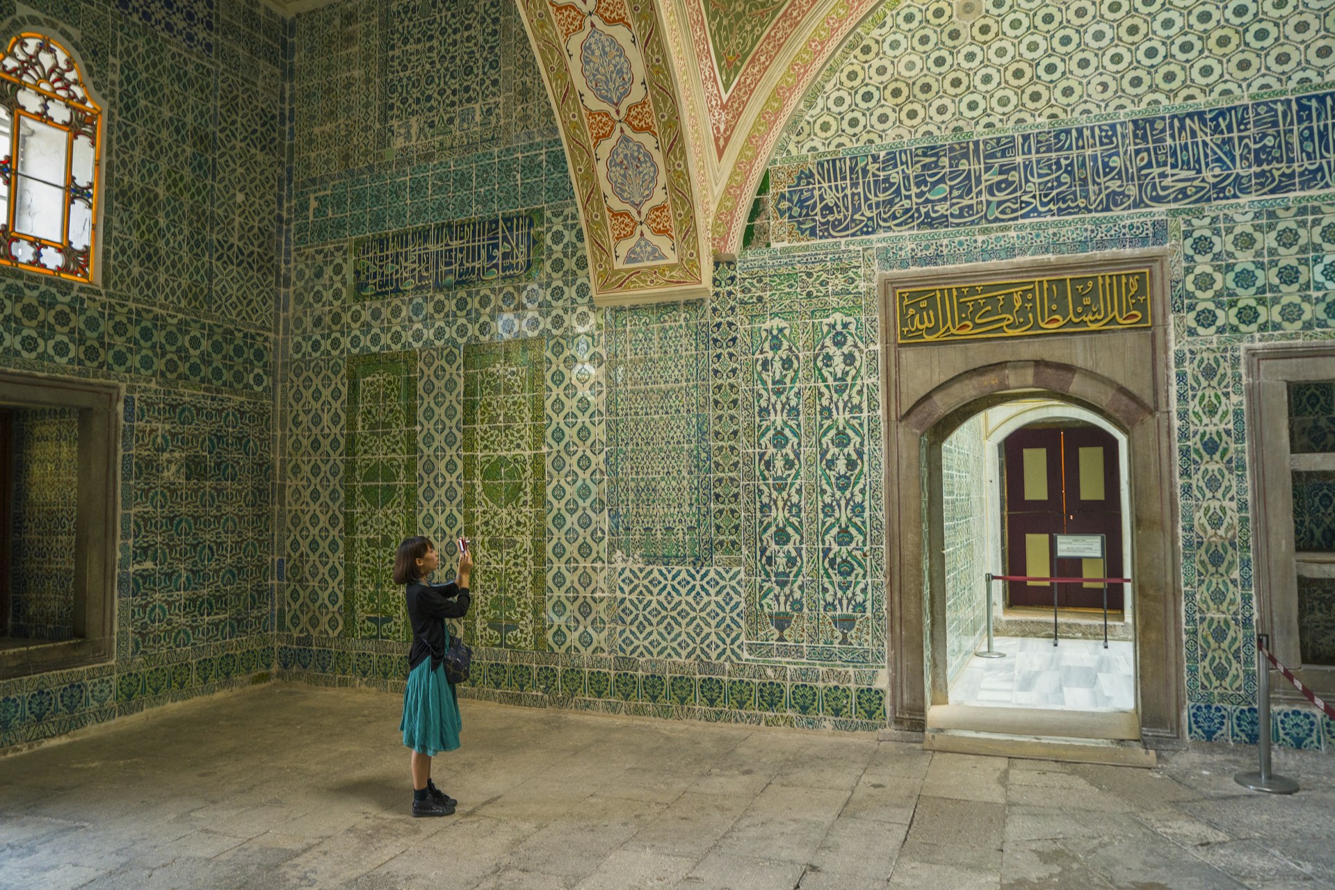 Visitor admiring the architecture of Topkapi Palace in Istanbul, Turkey