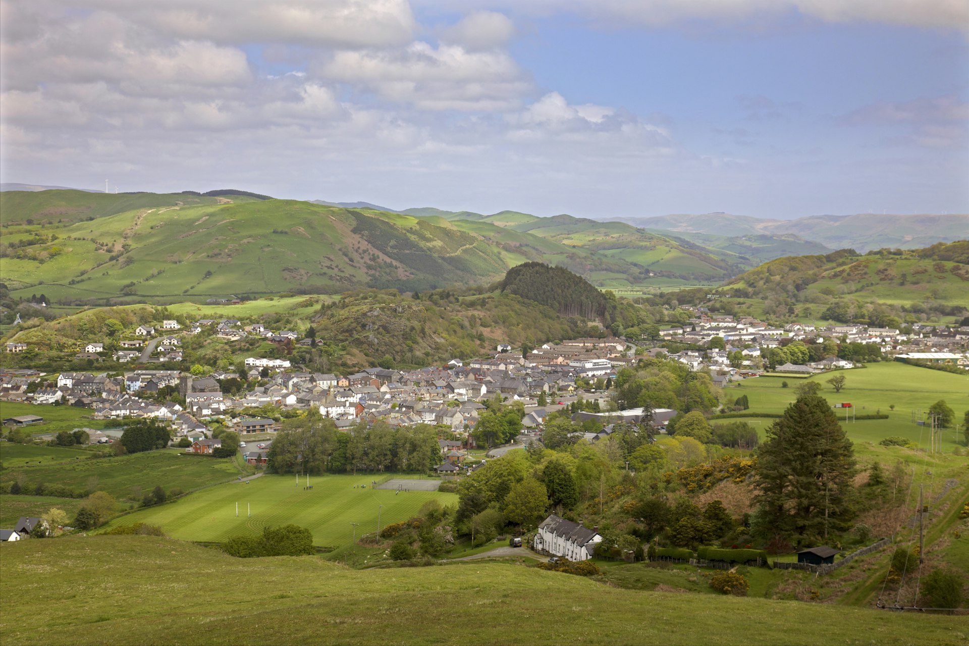 A town surrounded by green rolling hills