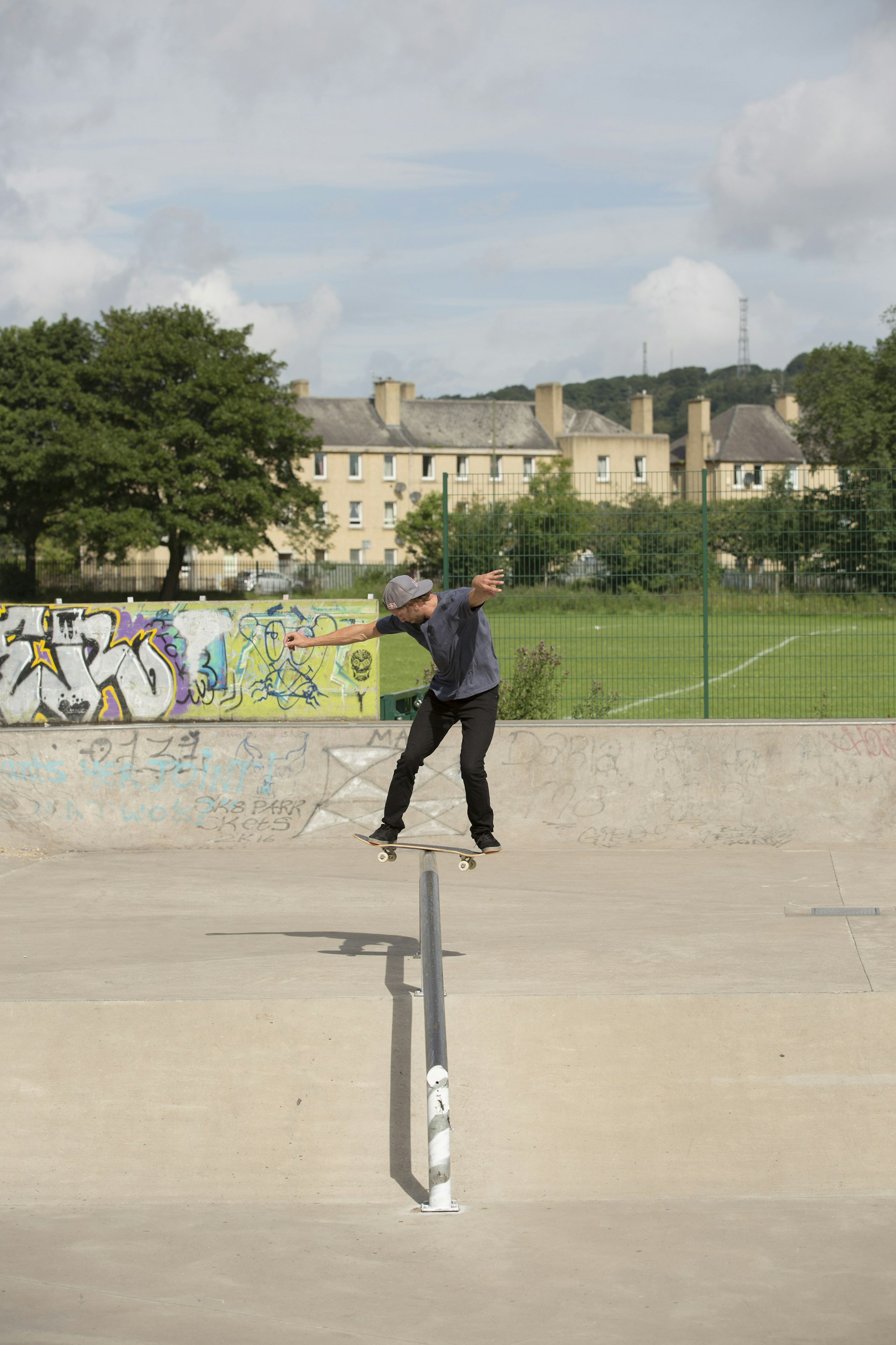 A skateboarder performs a trick on a rail