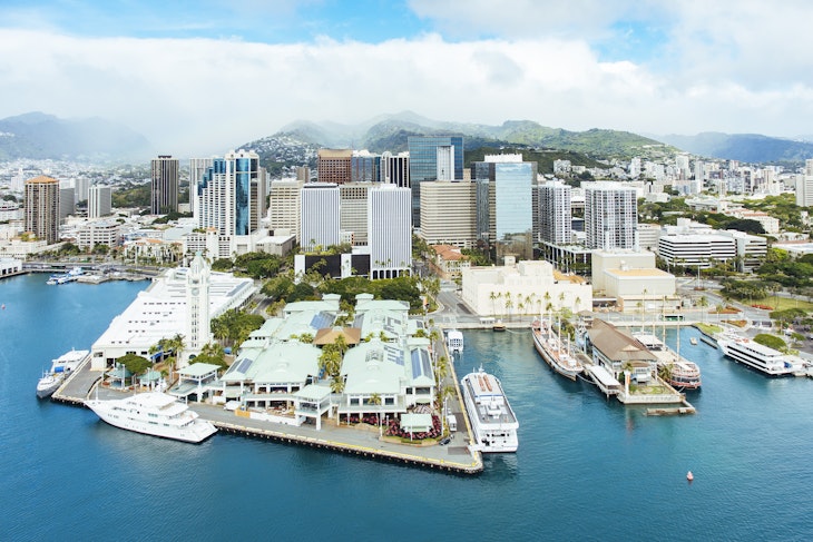 Aerial of Honolulu Harbor, Aloha Tower & Marketplace and the downtown city skyline.
