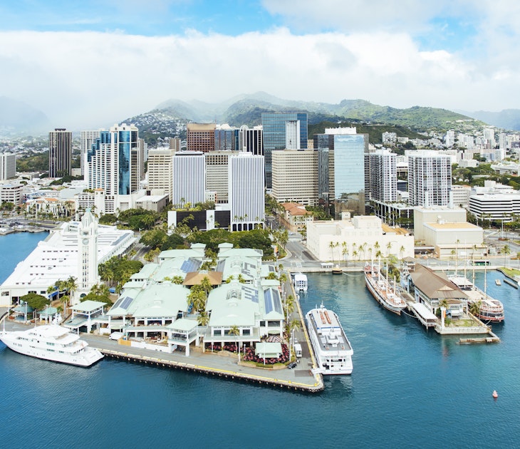 Aerial of Honolulu Harbor, Aloha Tower & Marketplace and the downtown city skyline.