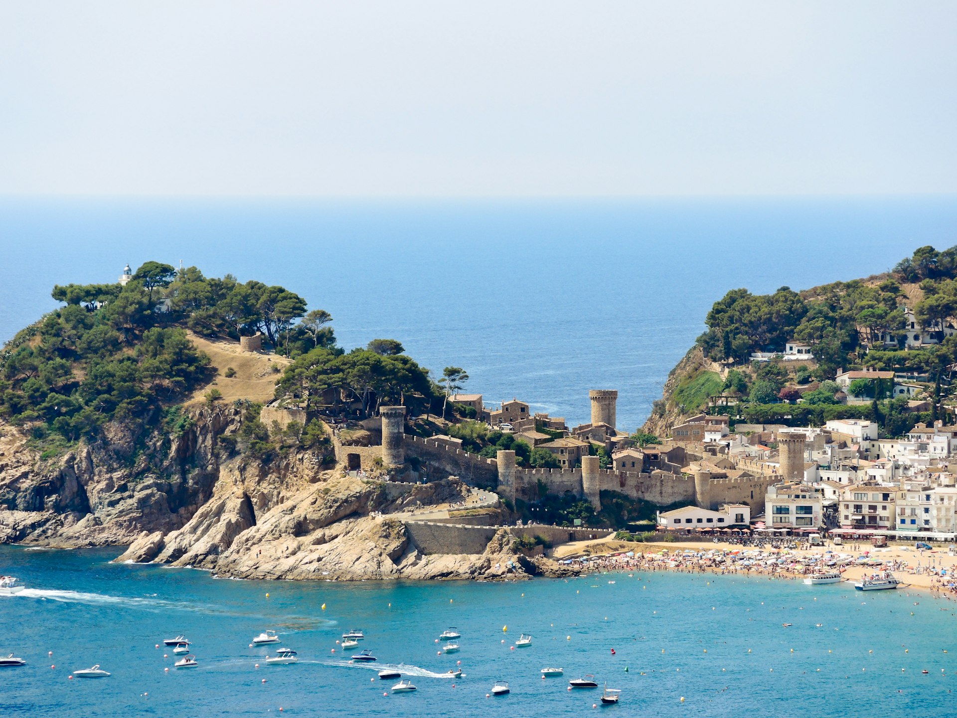 A coastal fortress on a small peninsula with sea either side sparkling in the sunshine