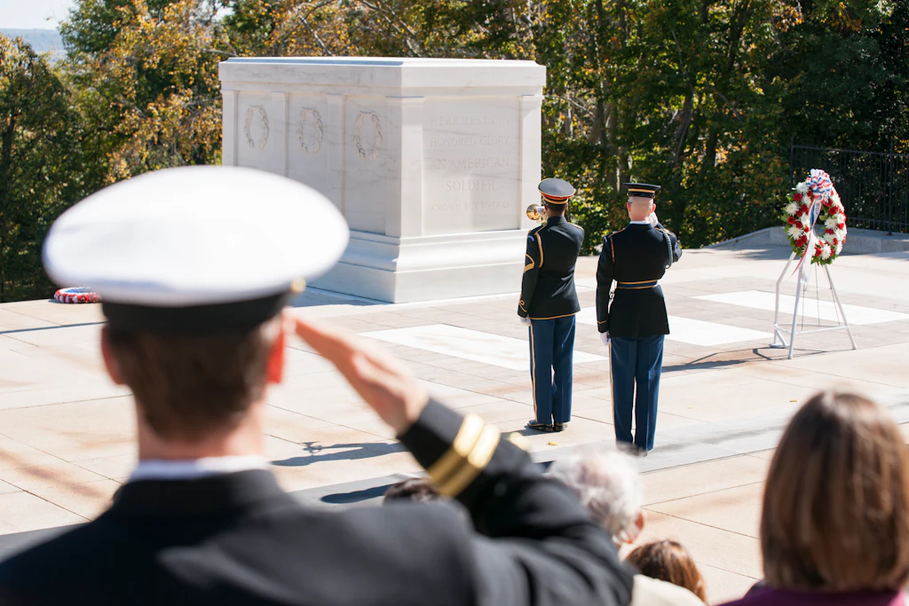 Arlington, Changing of the Guard. A white tomb is saluted by guards in uniform