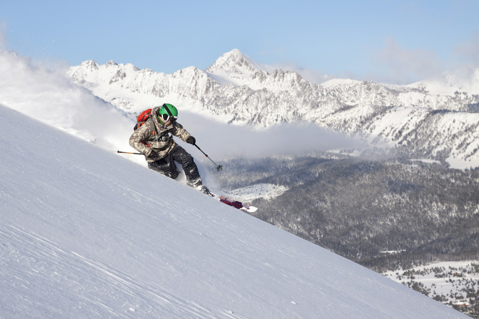 A male skier skiing untracked powder at Big Sky Resort in Big Sky, Montana
