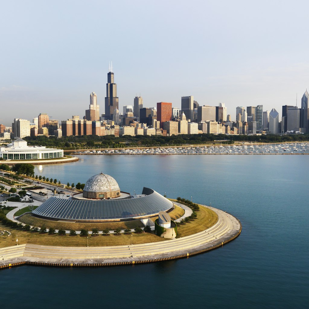 Aerial of the Adler Planetarium and Chicago city skyline.