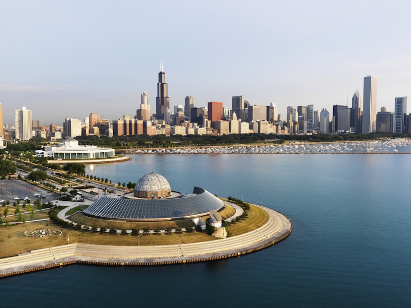 Aerial of the Adler Planetarium and Chicago city skyline.