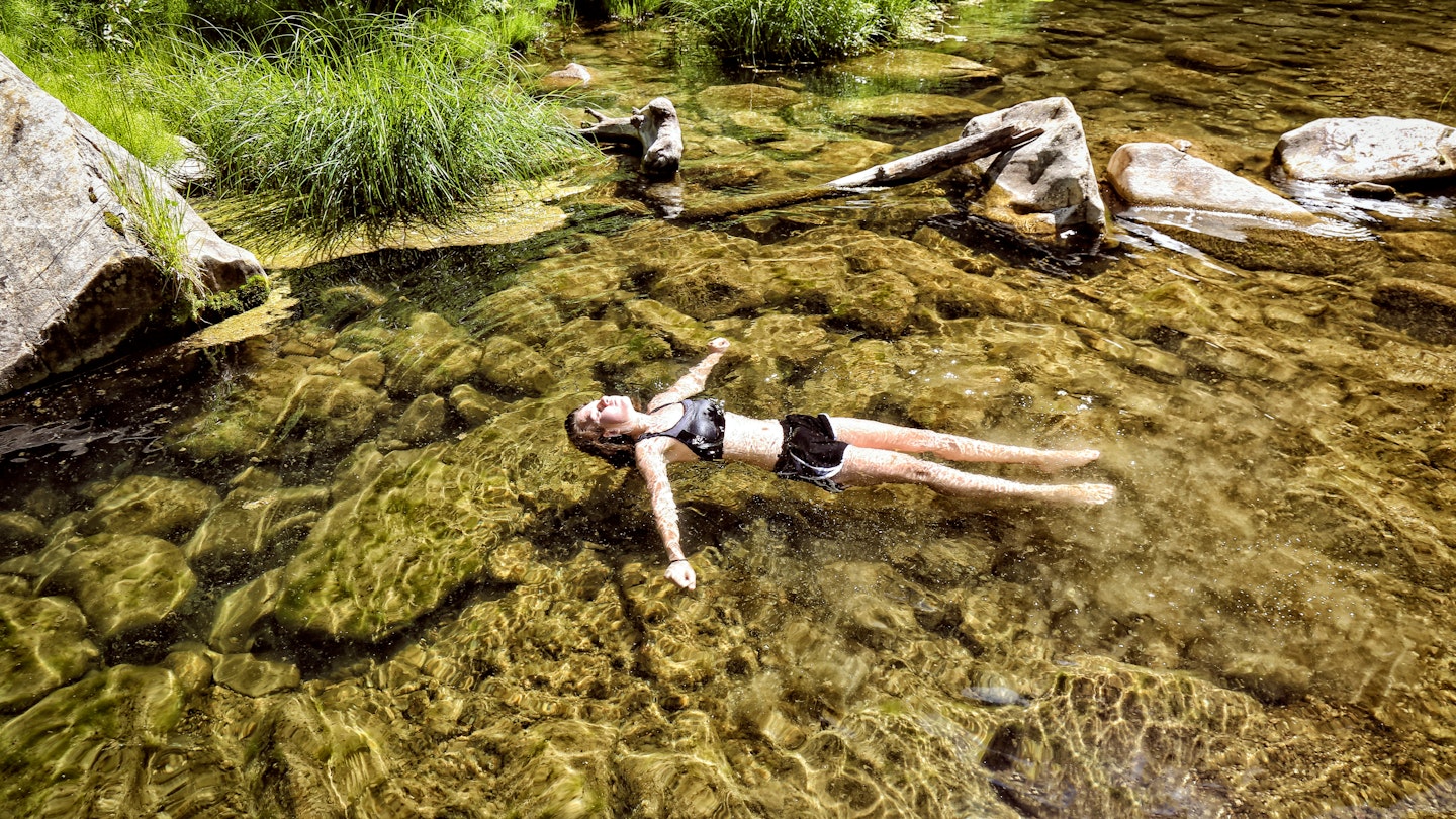 Girl floats peacefully in the clear desert water of West Clear Creek, Arizona.