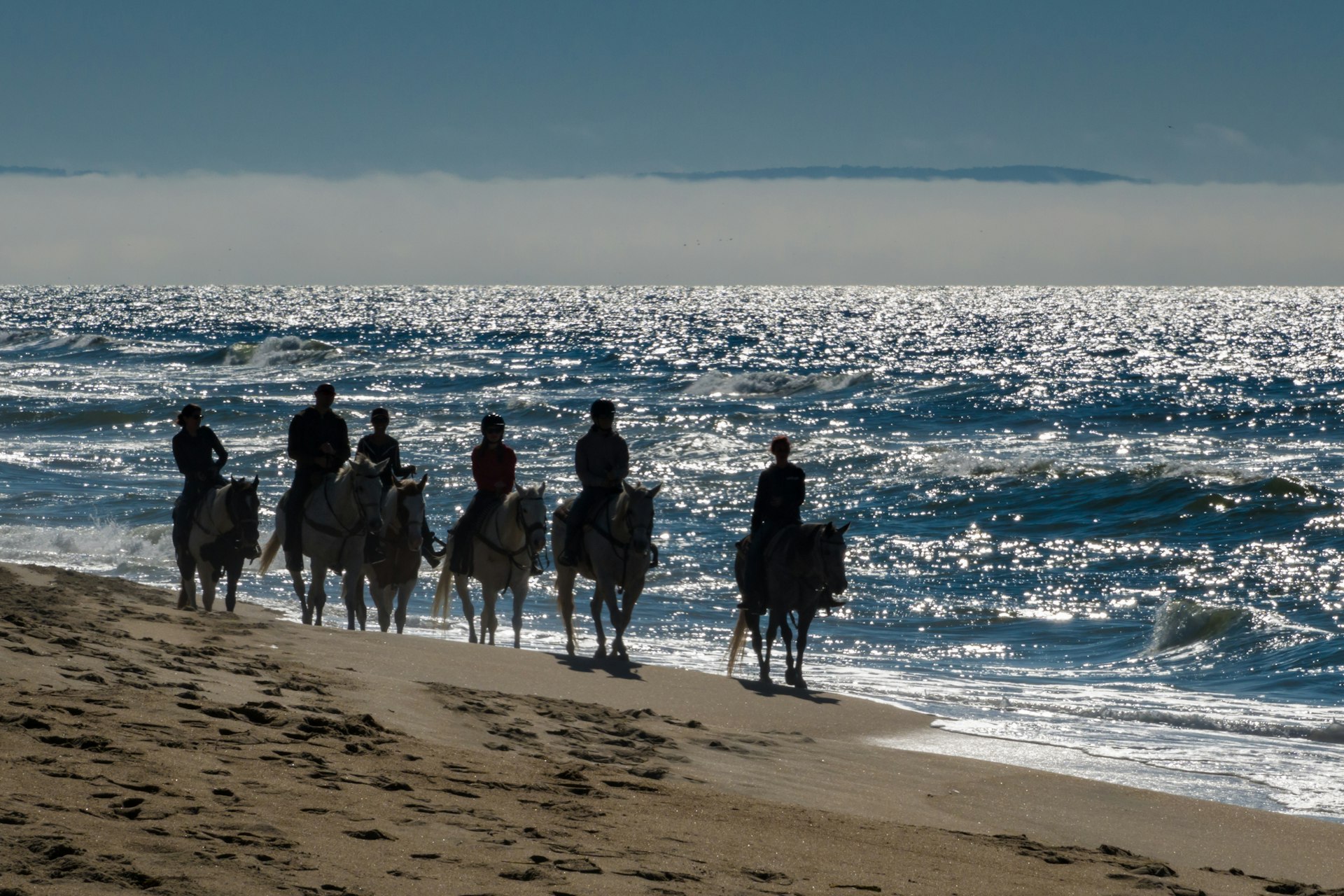 Horseback riders on a beach in Monterey Bay