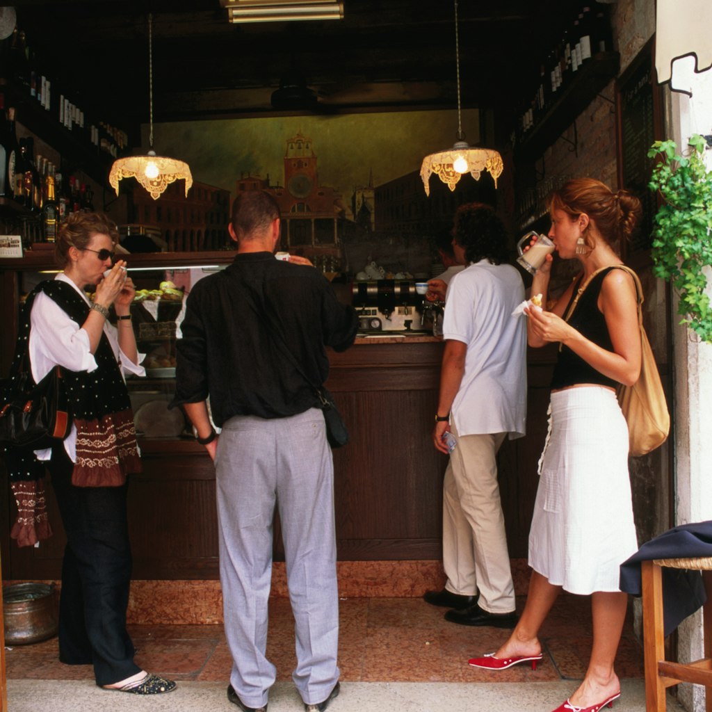 Locals take a standing coffee at Al Marca cafe.