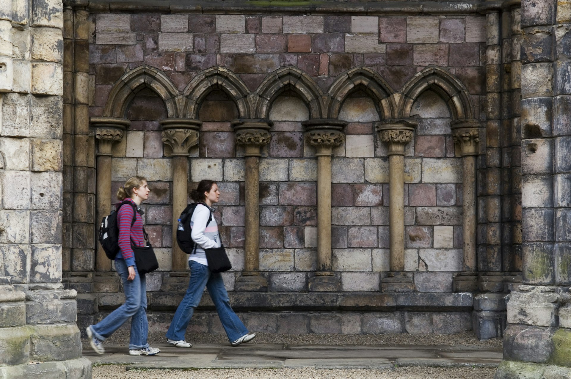 Two women walking in Holyrood Abbey at Palace of Holyroodhouse, Holyrood district.