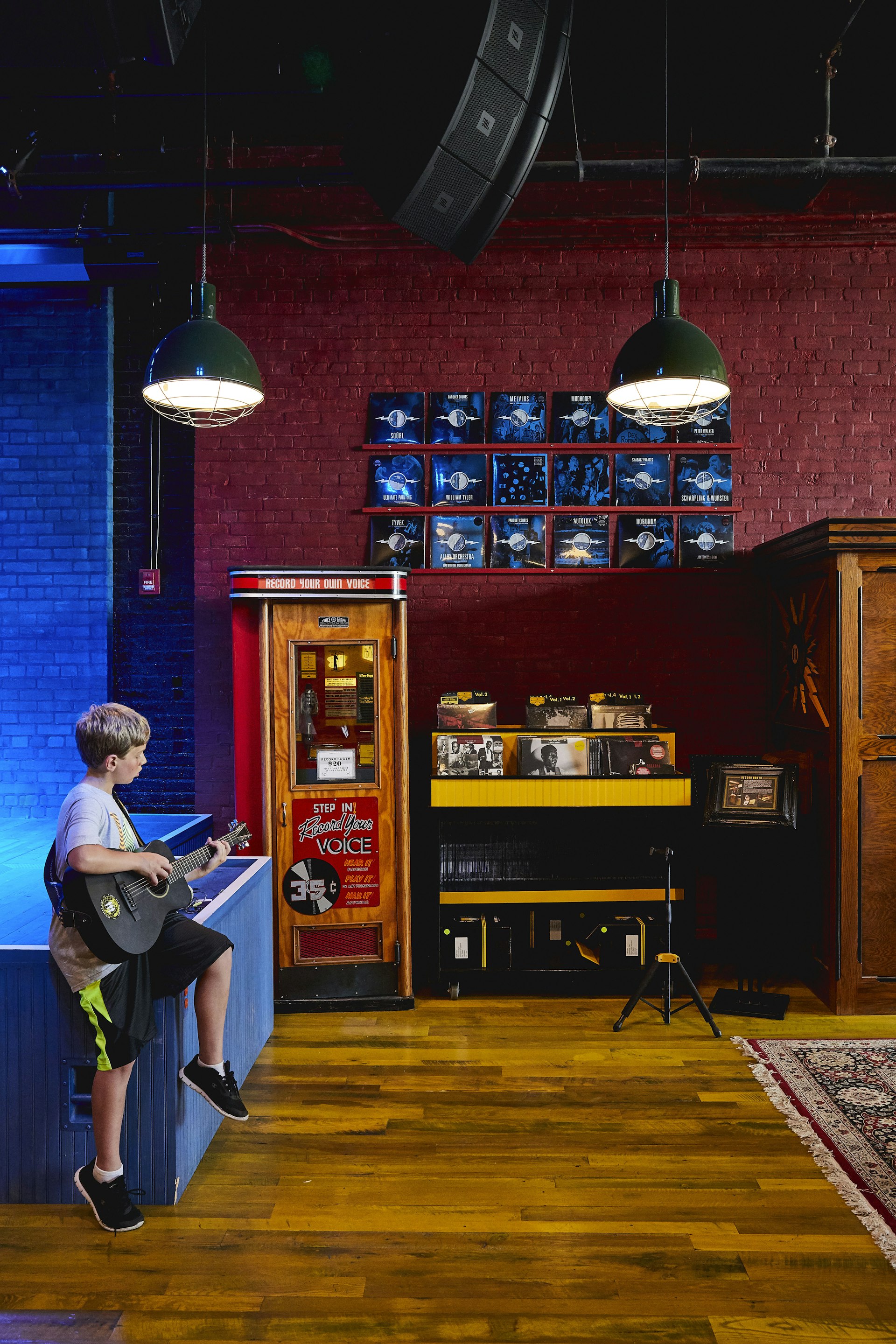 A boy plays guitar at Third Man Records, Detroit Michigan