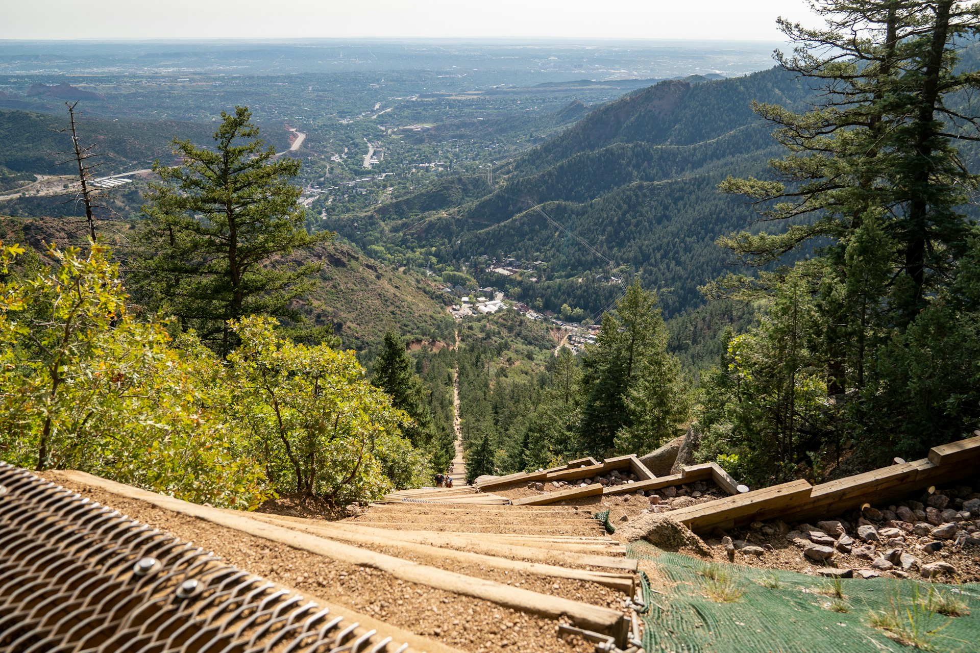 A look down at the old railroad ties making up the steep Manitou Incline, mountains in the distance