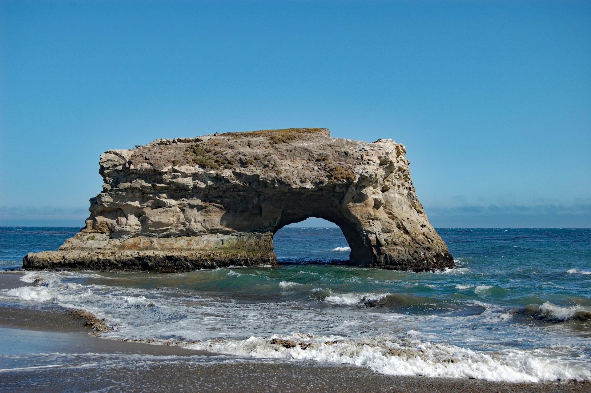 A sea arch next to natural bridges state beach 