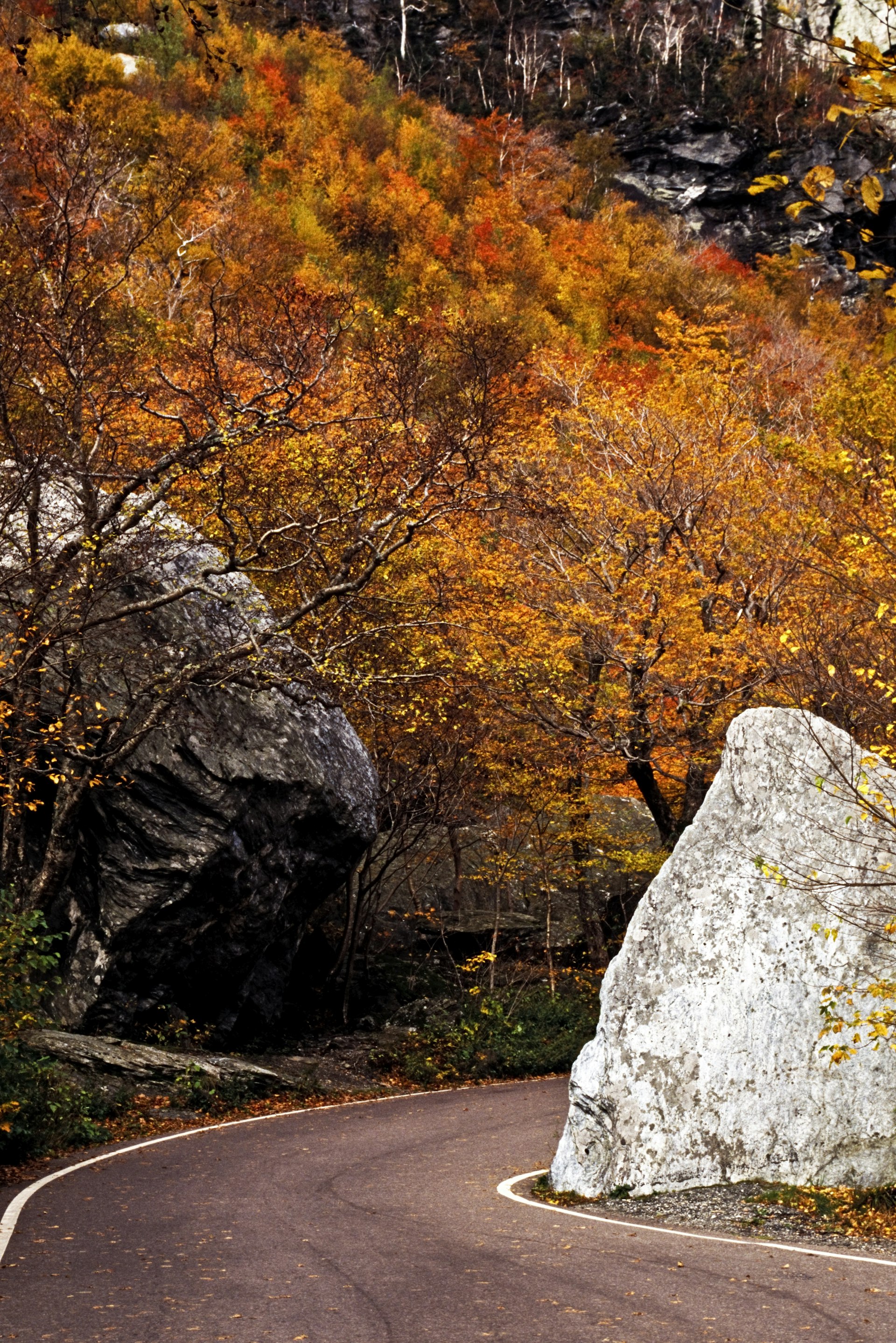 A pair of large boulders flank a single-lane road on the scenic highway called Smugglers' Notch in Vermont 