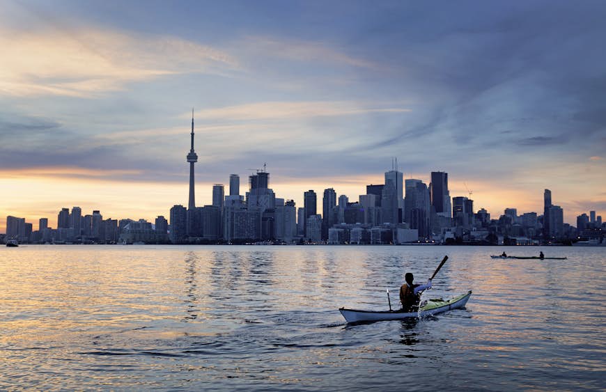 A kayaker in front of the Toronto skyline