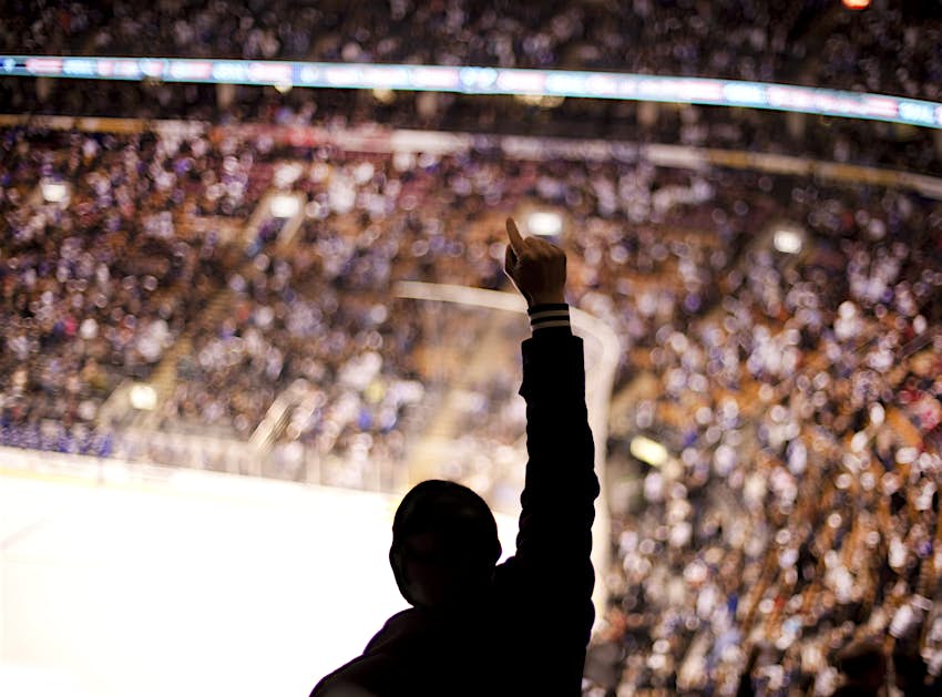 Sports fan cheering at hockey match