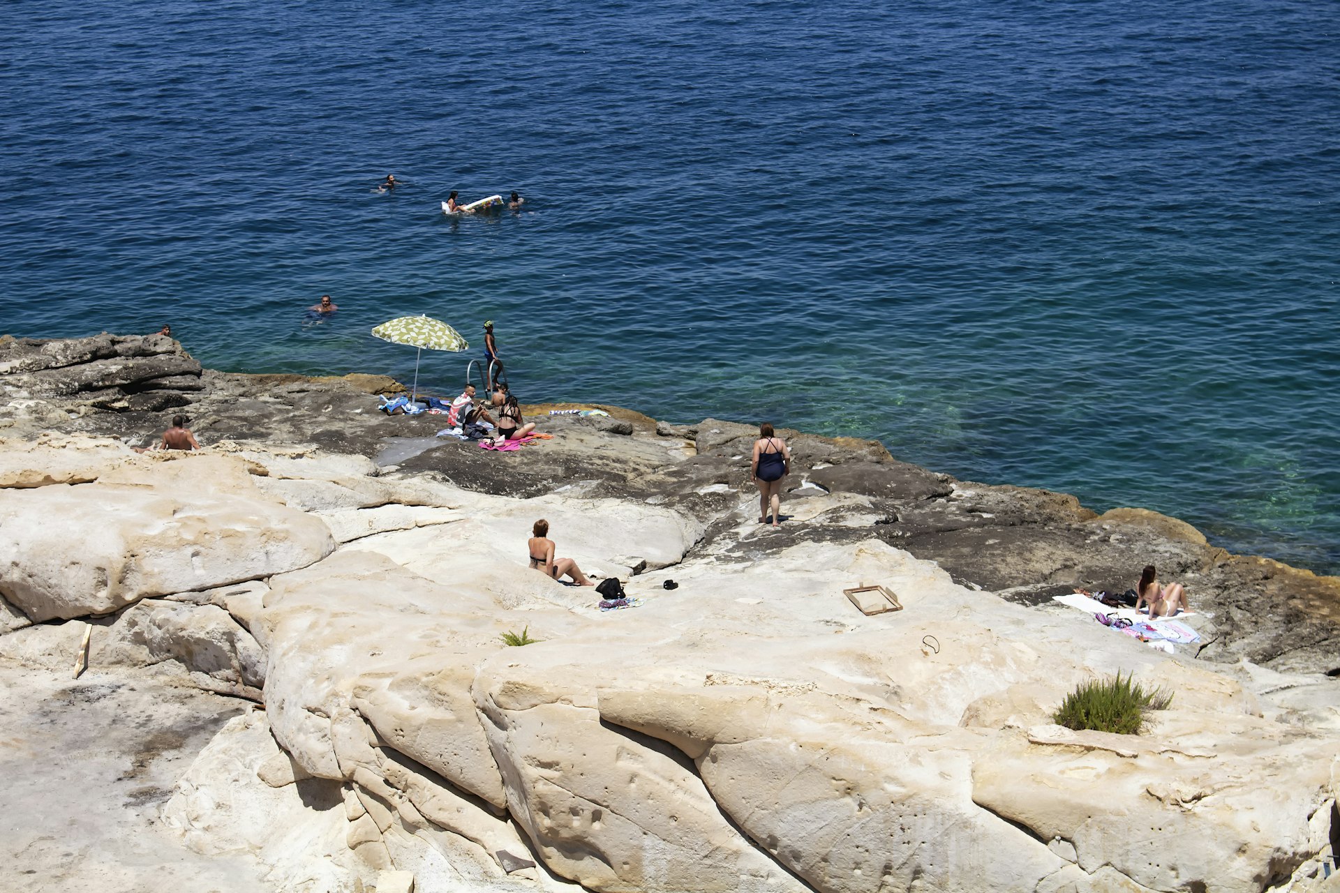 People swim and take sun bath in Valletta city / Malta.