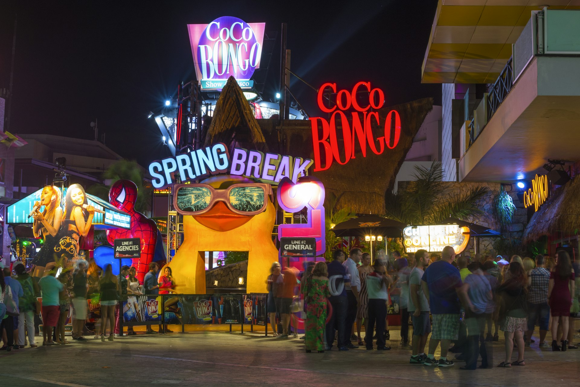 tourists stand in long lines to enter the popular Coco Bongo nightclub in Cancun at the start of Spring Break