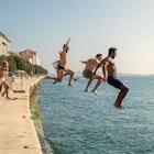 ZADAR, CROATIA - SEPTEMBER 2018. Group of courageous people jumping into harbour sea of Zadar, Croatia.