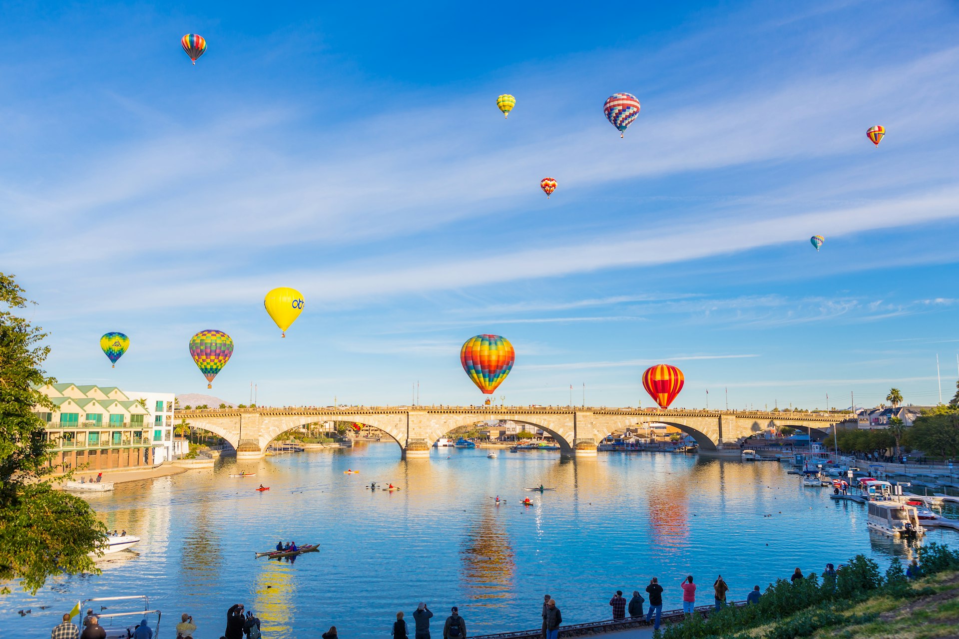 Hot air ballons rise over an arched bridge