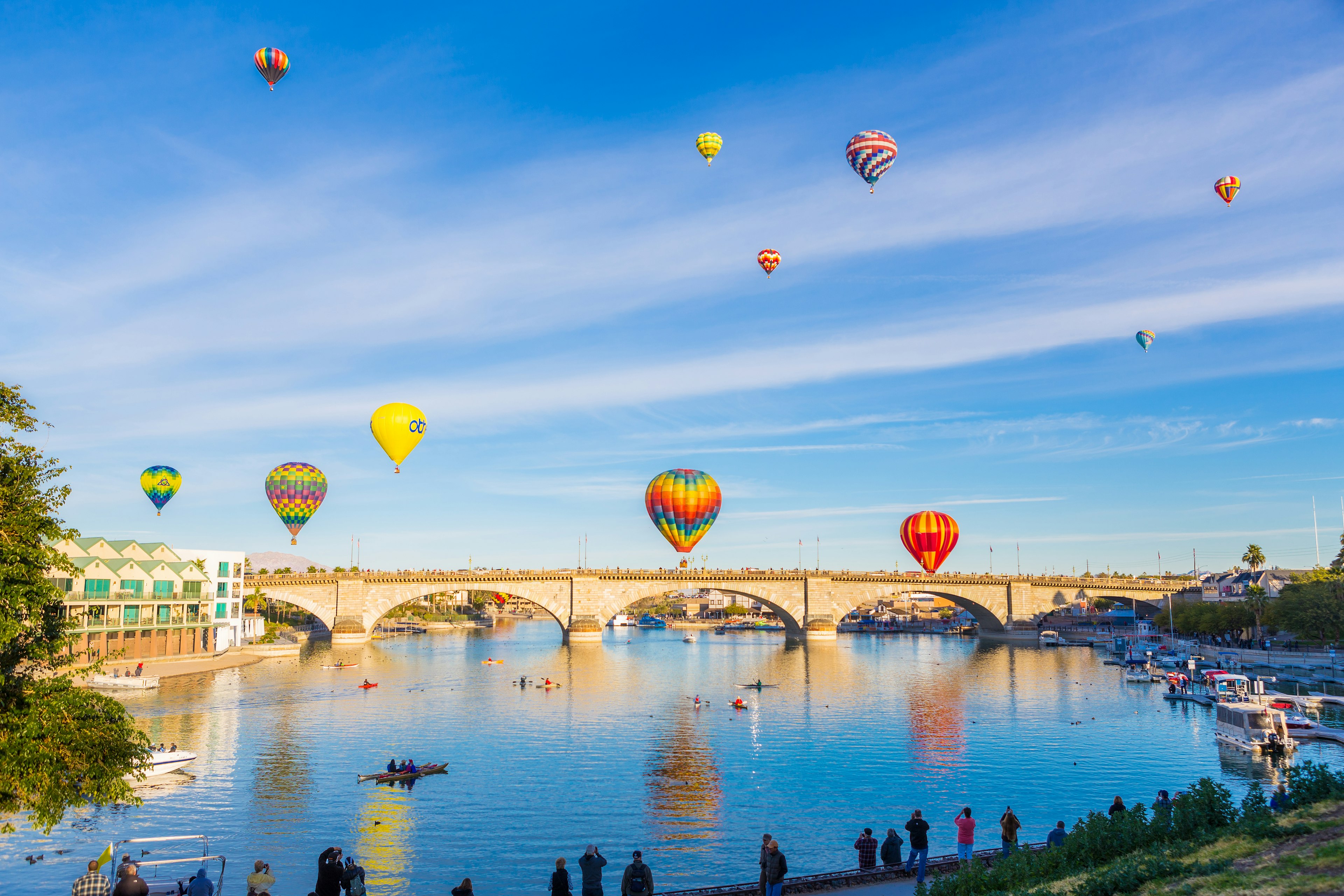 Hot air ballons rise over an arched bridge