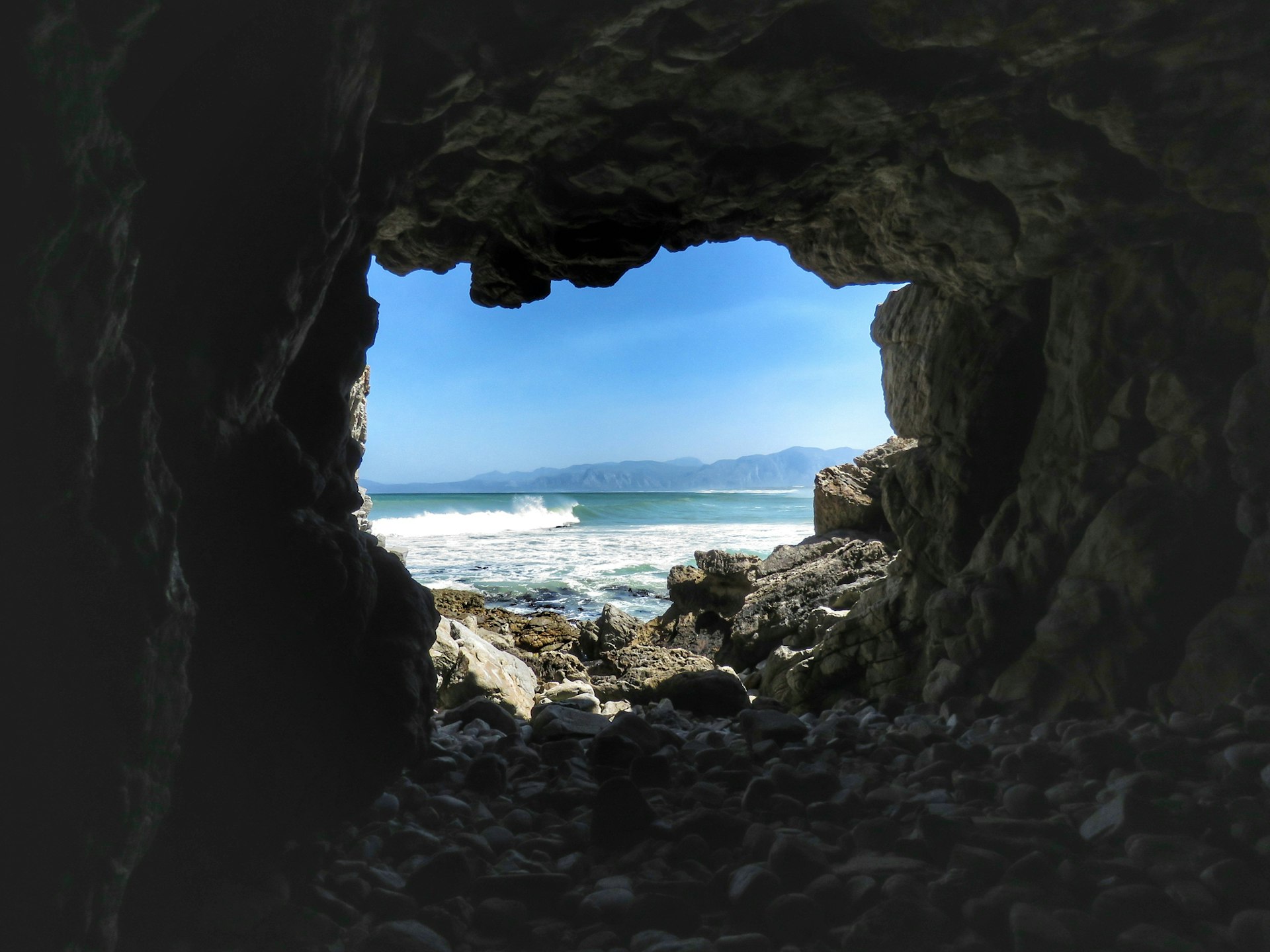 Scenic View Of Sea Seen Through Cave