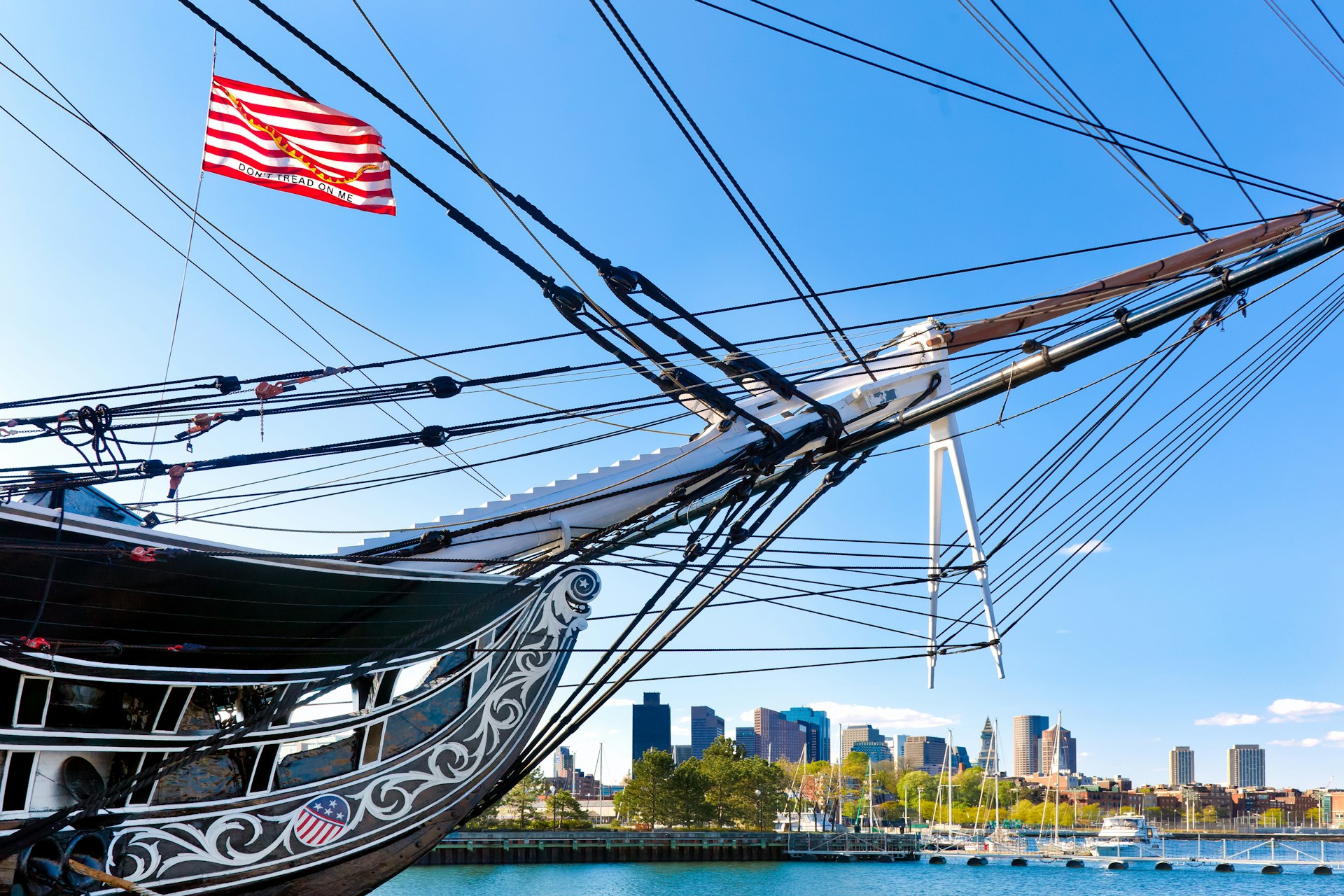 Boston skyline framed by the USS Constitution on a sunny day