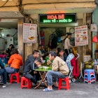 JANUARY 21, 2018: People eating at a street café in the old quarter of Hanoi.