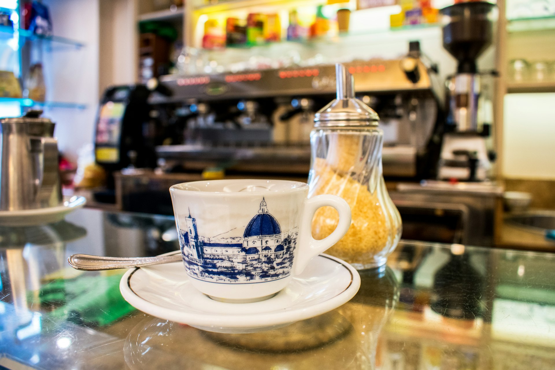 a small cup of espresso coffee and sugar on the counter of a cafe in Florence. 