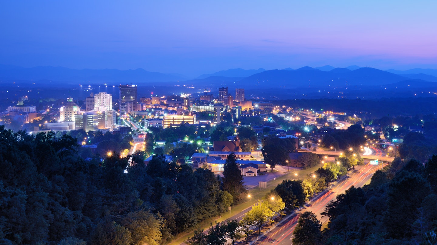 Asheville, North Carolina skyline nestled in the Blue Ridge Mountains.