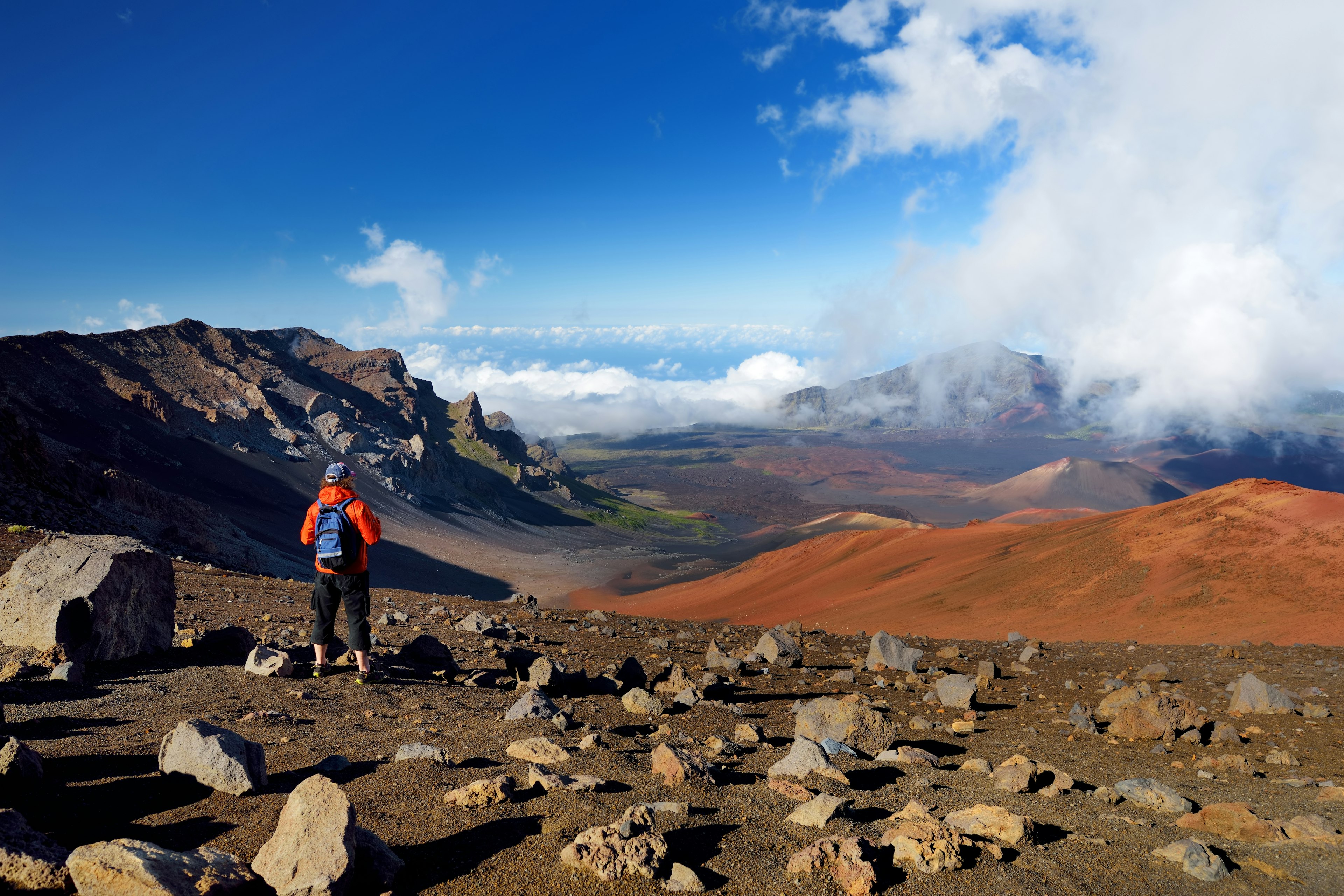 A hiker on the Haleakalā volcano crater on the Sliding Sands Trail on Maui, Hawaii