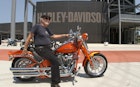 July 1, 2008: An elderly man on an orange Harley-Davidson in front of the HD museum.