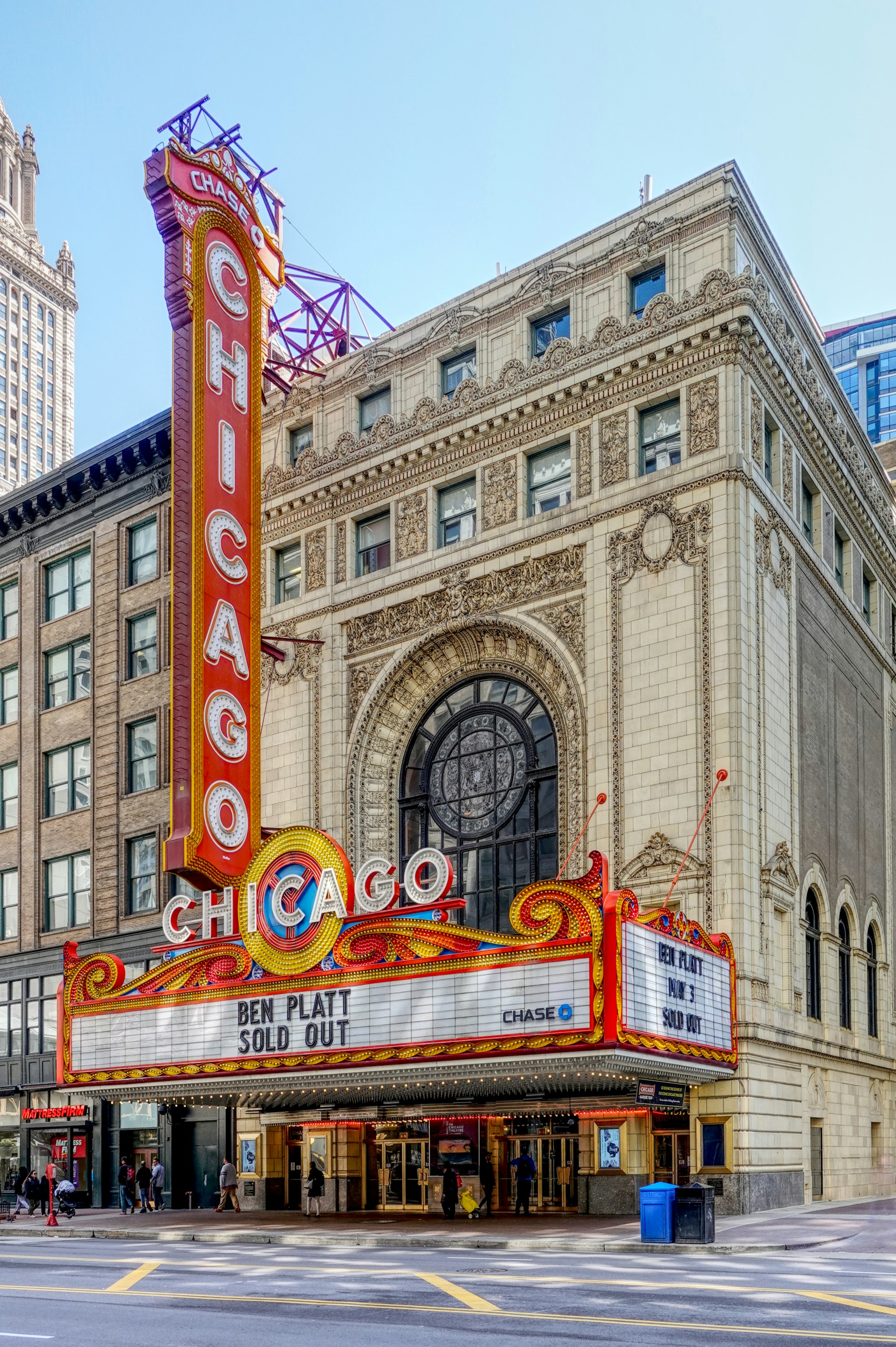 A red-and-white sign saying "Chicago" outside a traditional theater