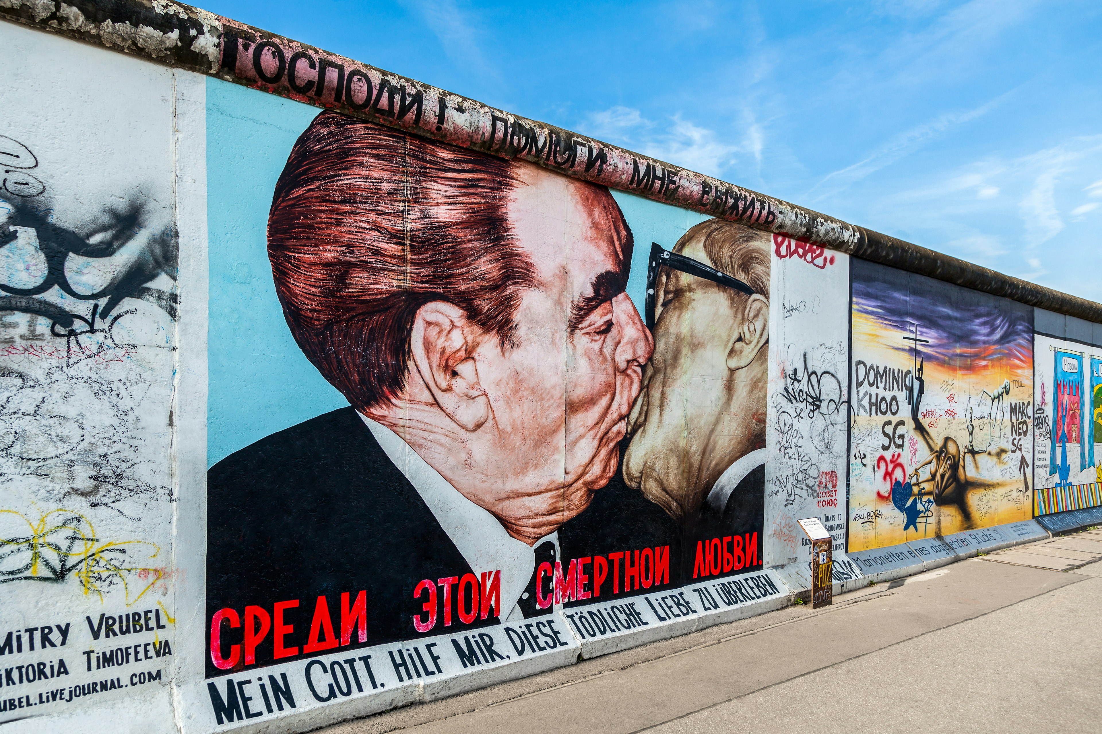 Berlin Wall graffiti (titled My God, Help Me to Survive This Deadly Love) seen on the East Side Gallery featuring Leonid Brezhnev and Erich Honecker kissing.