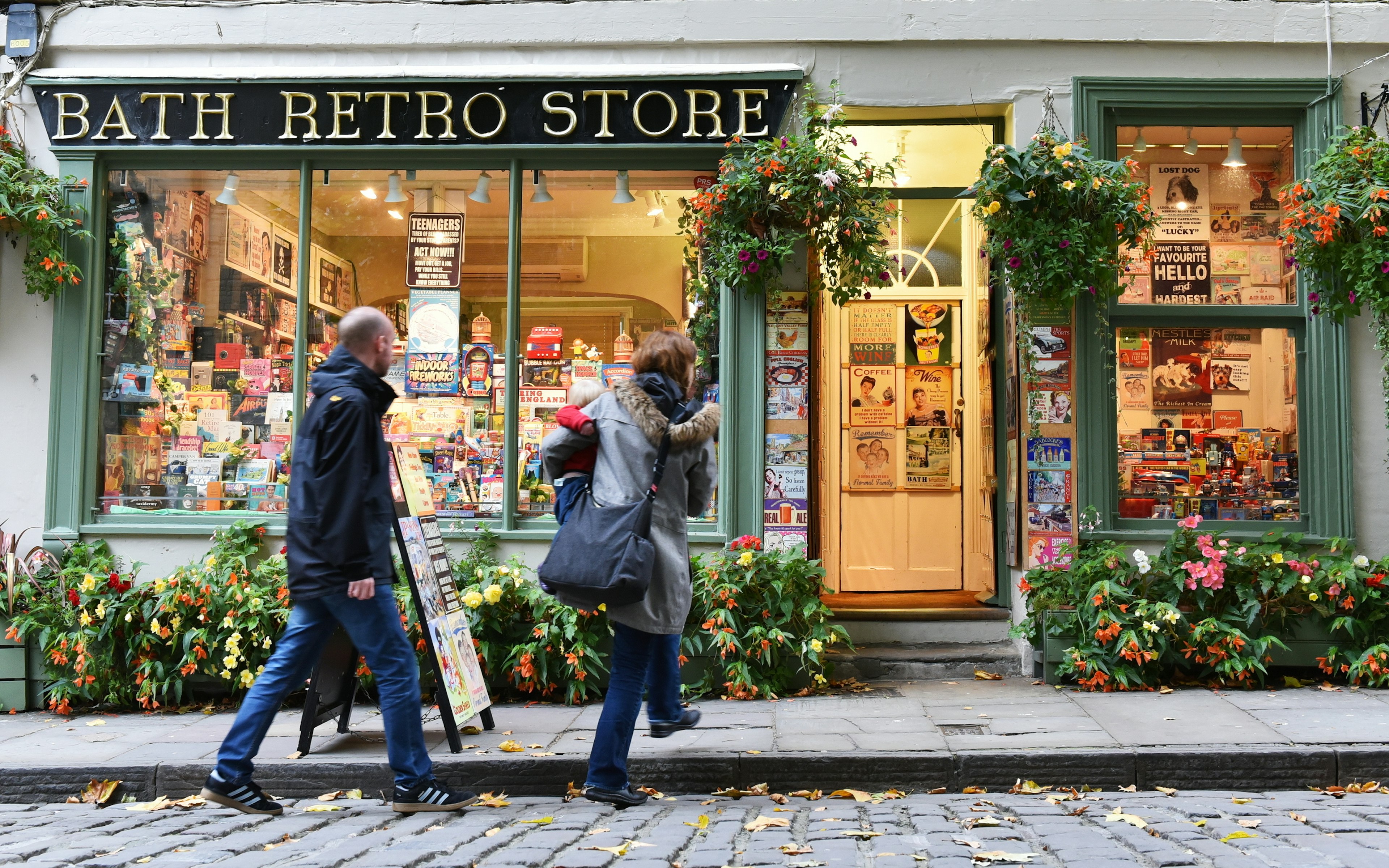 BATH, uk - OCT 18, 2015: People walk past a retro store on a city centre street. The Unesco World Heritage city in Somerset is famous for it shopping, attracting around 4 million visitors a year.