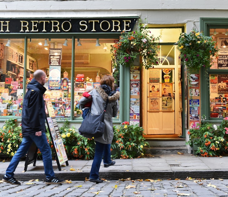 BATH, uk - OCT 18, 2015: People walk past a retro store on a city centre street. The Unesco World Heritage city in Somerset is famous for it shopping, attracting around 4 million visitors a year.
