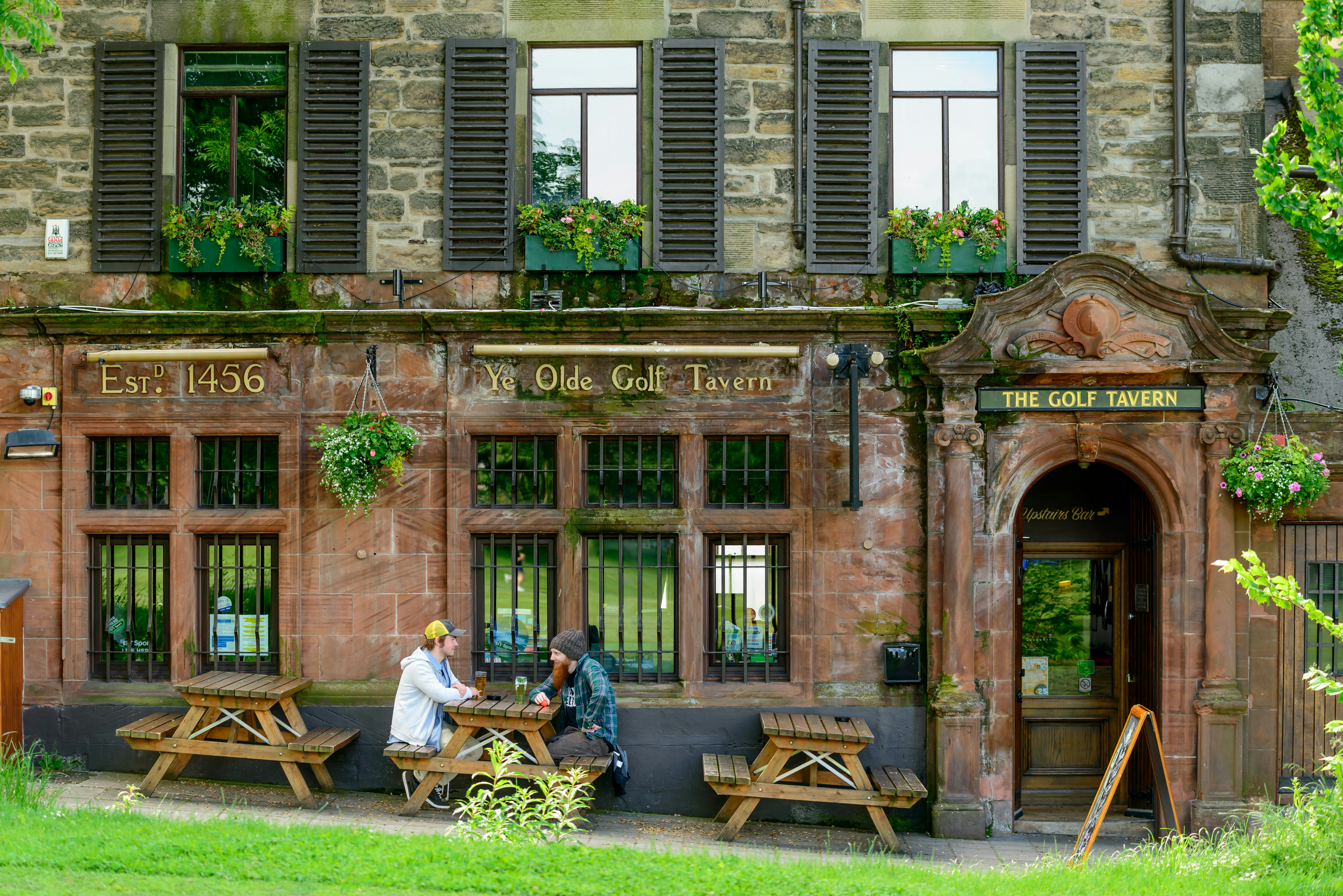 People drinking outside The Golf Tavern, Edinburgh, Scotland