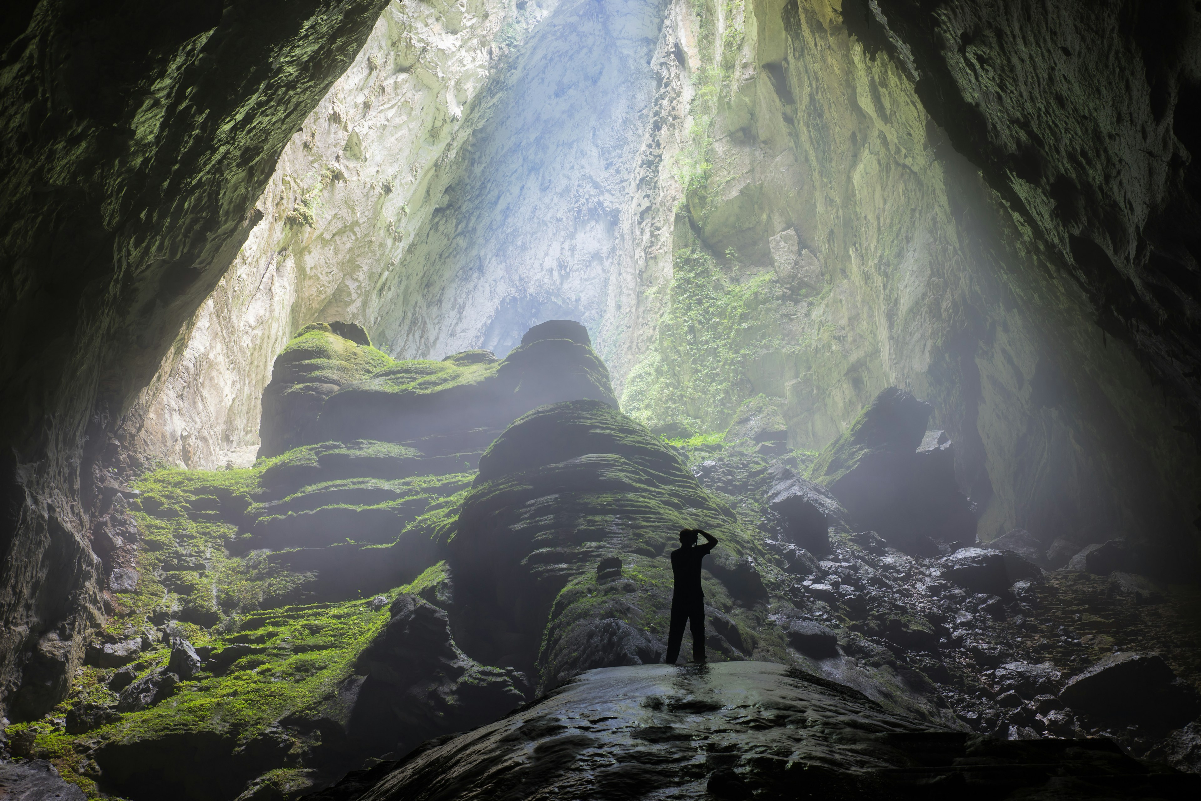 Man at the cave entrance in Son Doong Cave, the largest cave in the world in UNESCO World Heritage Site Phong Nha-Ke Bang National Park.