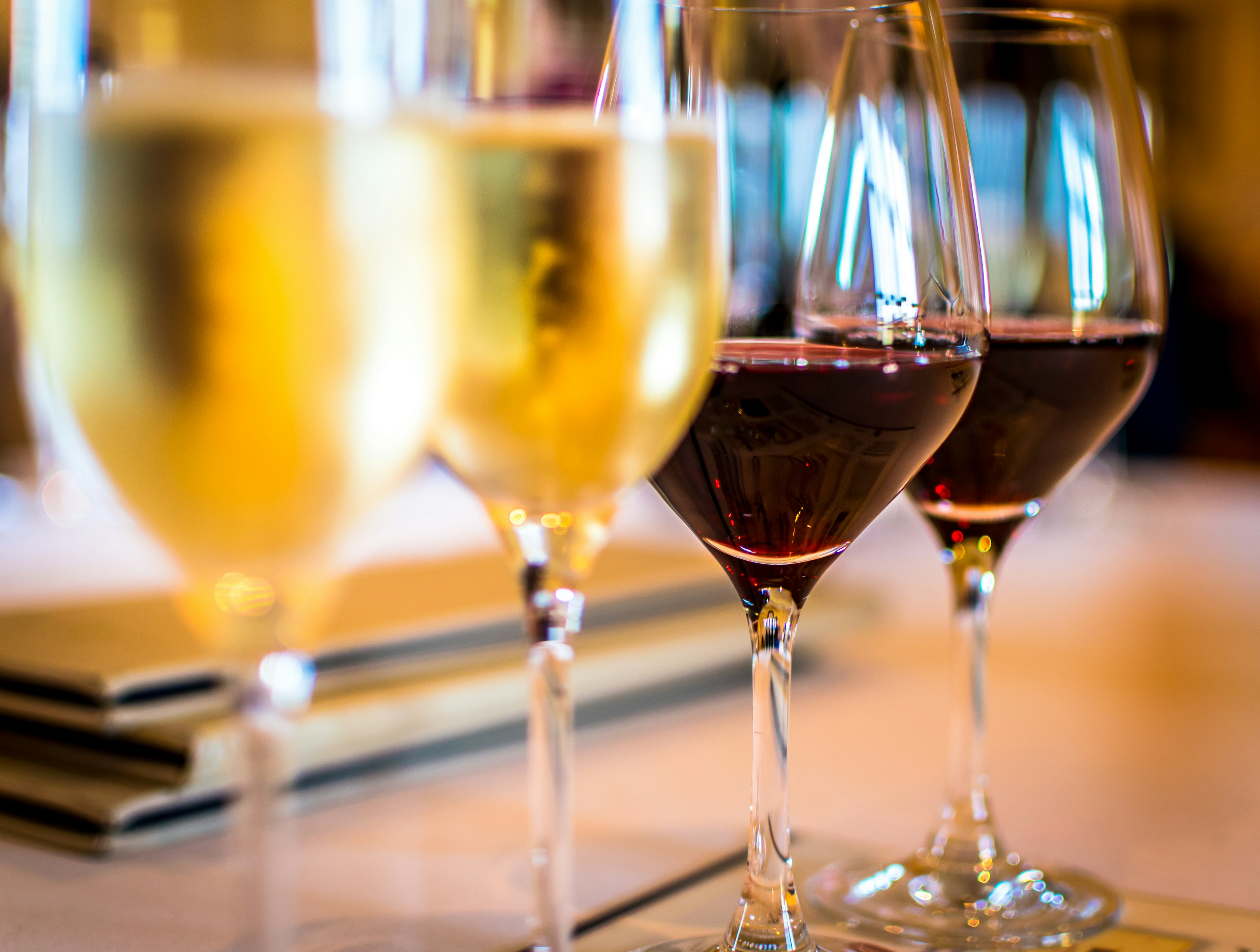 Wine glasses partially filled with red and white wine